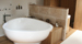Tiling for a contemporary oak and triangular bathroom design.